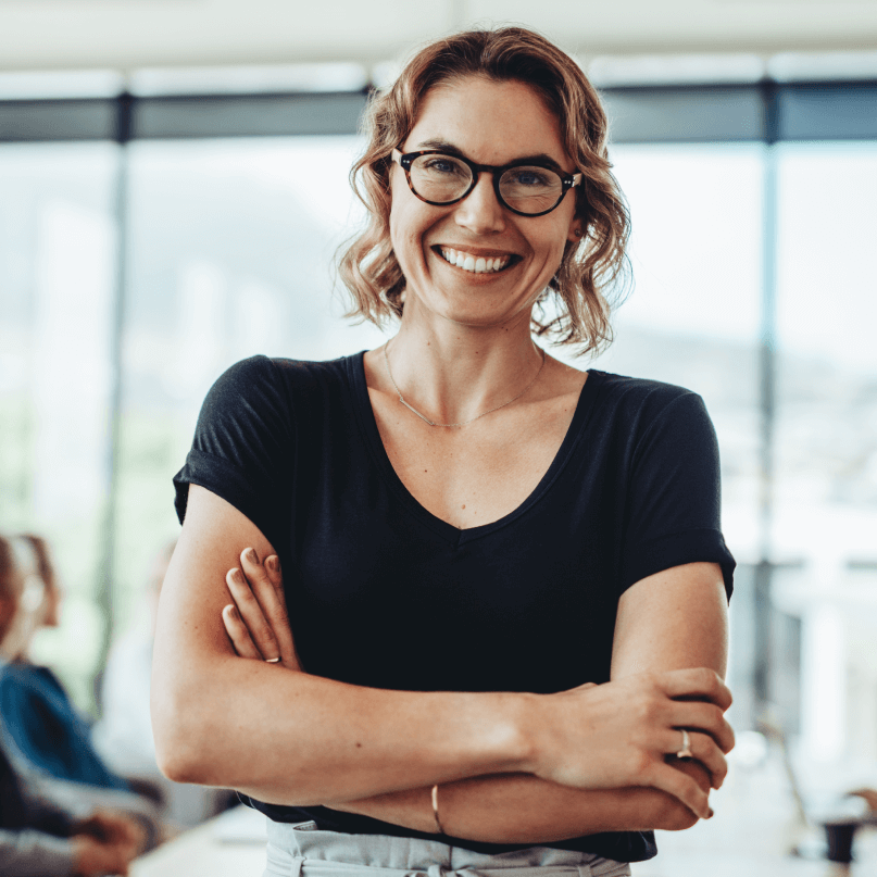 Young couple (Alex & MJ - On the GO) holding and lifting their baby daughter by the hands in the middle of a quiet street in Panama with many trees in the background – Family travel video editing service.