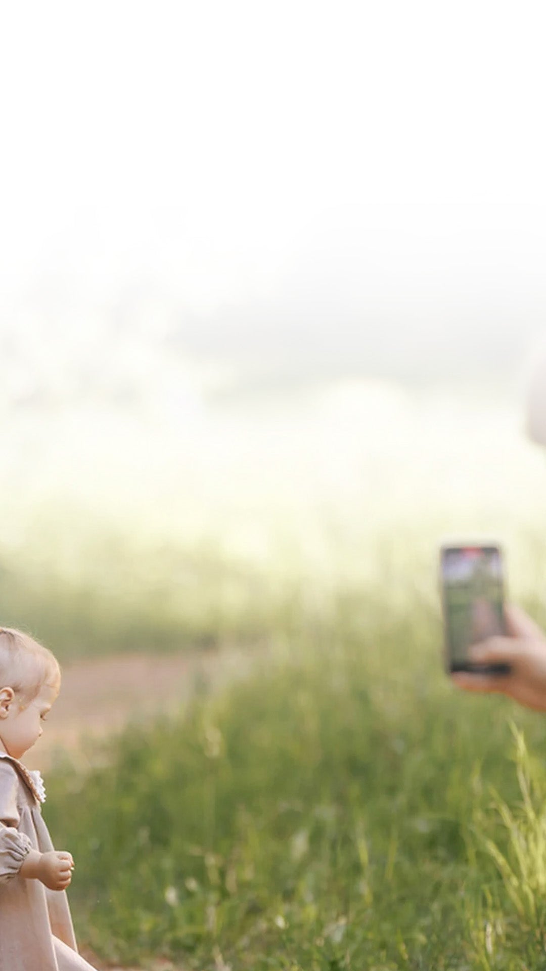 Mother taking phone videos of her young daughter that she will later get edited by a professional video editing service.